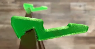 The finished, green 3-D printed kick stand