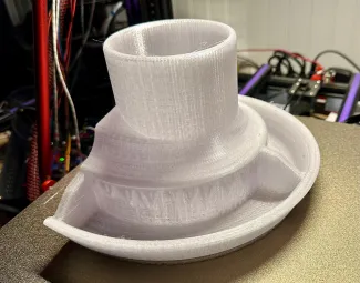 Completed 3D print of chicken feeder in white filament