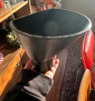 Hand holding a custom black funnel