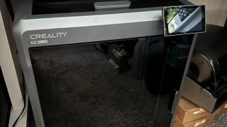 Creality K2 Plus printer on a carpeted floor